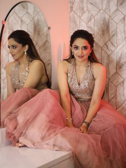 The full look, a beautiful pink tulle skirt paired with a sequined top. The soft glam makeup is the perfect finishing touch.