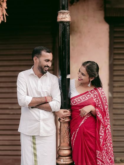 A sweet, smiling interaction by a lamppost. Using street elements as props can add character and a sense of place to the photos.