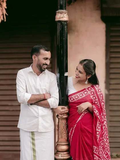 A sweet, smiling interaction by a lamppost. Using street elements as props can add character and a sense of place to the photos.