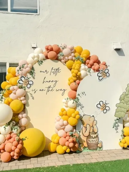 Another angle of the charming Winnie the Pooh setup, highlighting the full balloon arch and character placement.