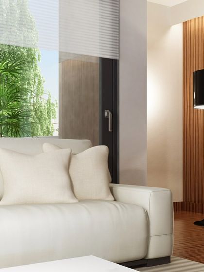 This view shows how our wall panelling can define an entire living space. The vertical fluted wood wall adds warmth and texture, harmonizing with the neutral tones of the furniture to create a calm and inviting atmosphere.