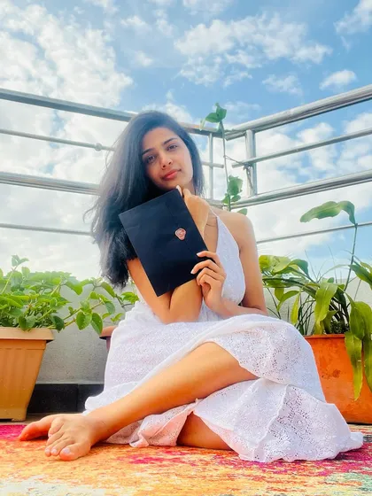 This is me, holding the very first prototype of a 'Love Posted' envelope against a hopeful sky. This simple black envelope, sealed with a heart, represents my dream of creating something tangible in a digital world. It’s the promise of a real connection, a poem waiting to be read.