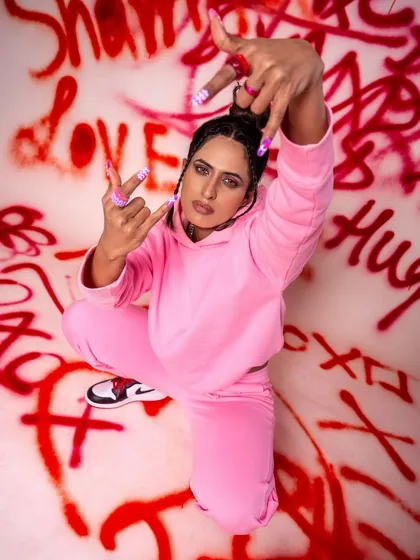 This shot from the graffiti set uses a wide angle to capture the model's pose and attitude, with the "love" and "hugs" text creating a fun, ironic contrast.