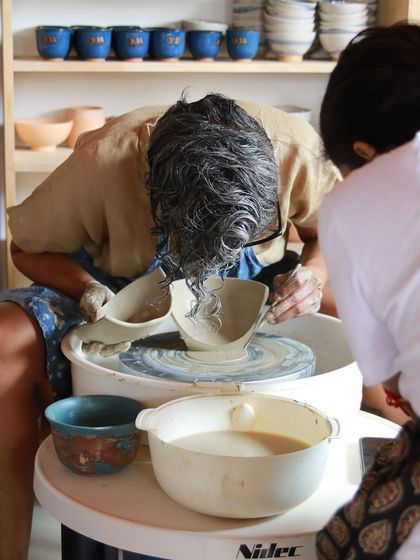 A close up of me demonstrating how to check the consistency of a glaze, a crucial step for a successful firing.