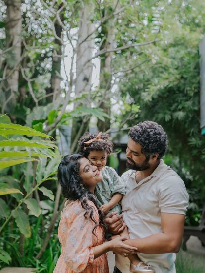 A family of three enjoying a beautiful day outdoors. The natural setting adds to the relaxed and happy vibe.