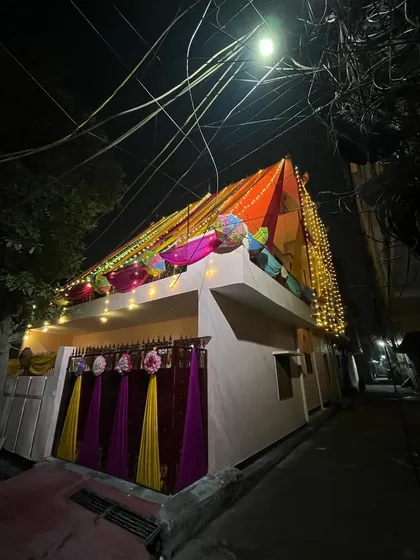 A wide shot showing how the decorated house stands out and lights up the entire street.