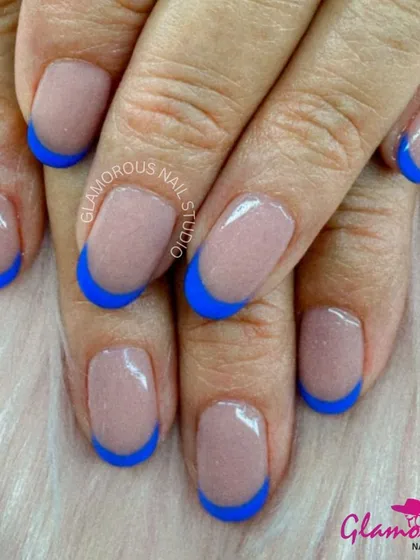 A classic French manicure with a bold twist. The clean nude base is paired with a vibrant, solid blue tip for a striking pop of color.