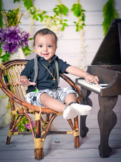 A happy little musician at his piano-themed birthday shoot.