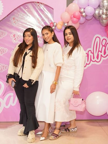 Guests posing in front of a Barbie-themed balloon arch. Our Instagrammable setups are a highlight of every party we host.