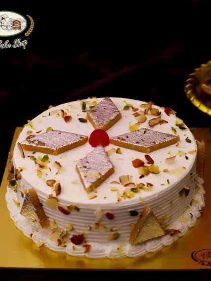 The Kaju Katli Cake is a unique fusion dessert perfect for Diwali. It features layers of moist cake topped with authentic kaju katli pieces and crunchy nuts.