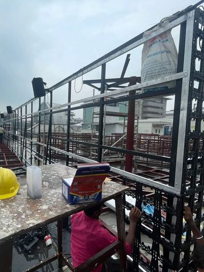 A shot of the vertical garden framework construction, showing the scale of the project against the city skyline.
