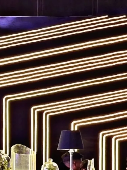 We created this custom neon light installation as a dynamic backdrop for the bar. The geometric lines of light add energy and a modern, club-like feel to the cocktail party.