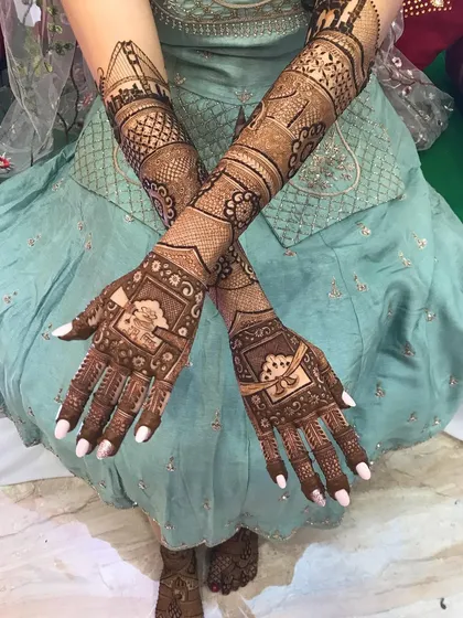 A beautiful shot of a bride's crossed arms, showcasing the symmetry and flow of the full-coverage design. The patterns are designed to look beautiful from every angle.