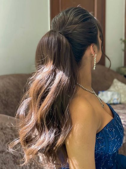 A close up of the ponytail, showing the detail of the hair wrapped base and the soft, flowing waves.