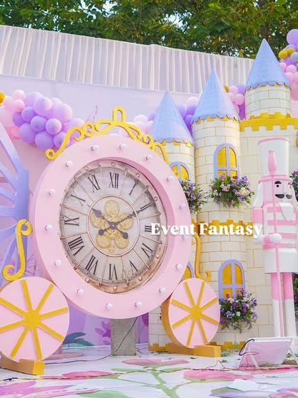 Another view of the clock carriage prop, a creative and unique element in the fairytale setup.