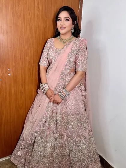 A beautiful full-length shot of her Sagan makeup and lehenga. The soft pink tones in her makeup perfectly match the delicate embroidery on her outfit.