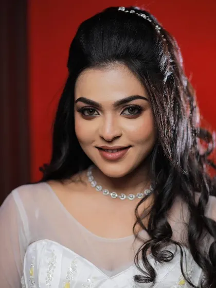 A close-up of a model's face, showing off a glamorous and elegant Christian wedding makeup look.