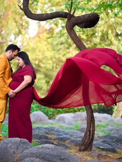 An intimate moment between partners during an outdoor shoot. The way they hold each other and the baby bump shows the love and excitement you share.