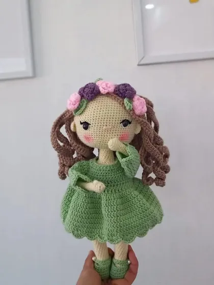 A sweet pose from one of my original doll designs, highlighting the hand-stitched face and the detailed flower crown.