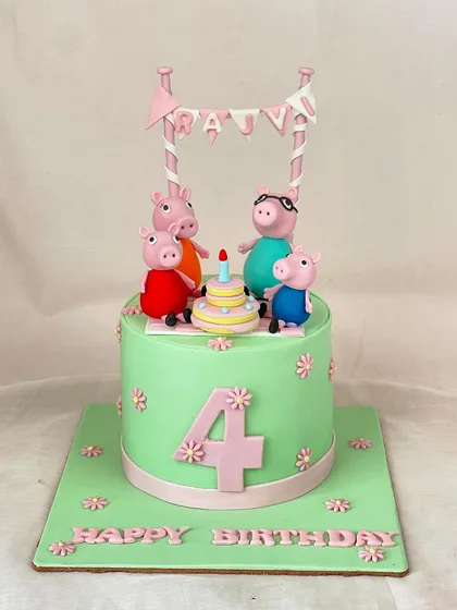 A fun and colorful Peppa Pig cake for a 4th birthday celebration. The whole family is here to party on this cheerful green and pink fondant creation.
