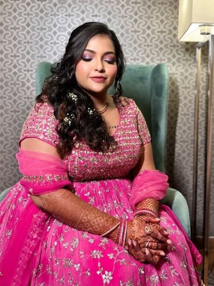 A serene portrait of the bride. The shimmery pink eye makeup perfectly matches her outfit.