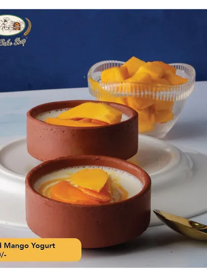 Our Baked Mango Yogurt is a celebration of summer, served traditionally in earthen matkas. We use fresh, ripe mangoes to create this light, healthy, and refreshing dessert that captures the taste of the season.