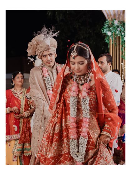 The couple taking their first steps together as husband and wife after the pheras. This candid moment is filled with the promise of a new beginning.