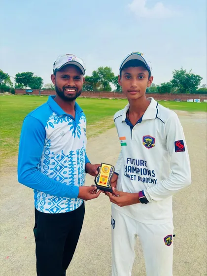 Aditya Singh receiving the Player of the Match award from the coach. A proud moment for the young cricketer.