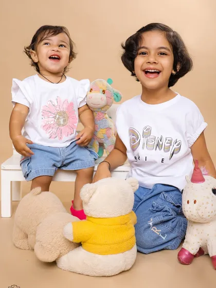 Two sisters sharing a laugh surrounded by their favorite stuffed animals. We create a fun and relaxed atmosphere to capture genuine moments of joy between siblings.