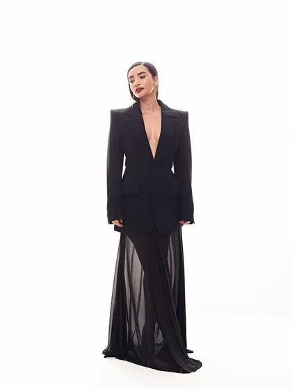 A full-length view of Patralekhaa's powerful look. The oversized Balenciaga blazer paired with a sheer mesh skirt from Harshita Nagiofficial creates a beautiful play on contrasts.