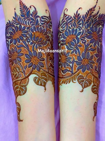 A stunning arm design with bold, sunflower-like flowers.