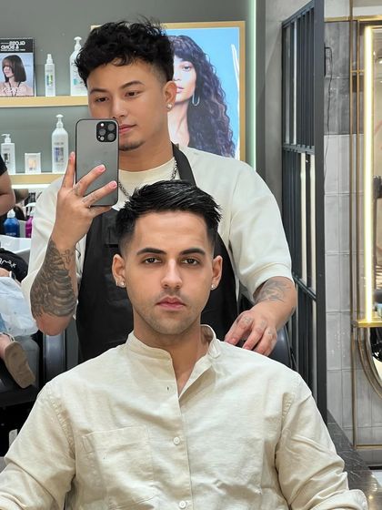 A front view of this clean men's cut. The fade is seamless, and the top is styled for a modern, polished look.
