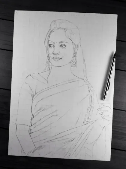 The initial pencil outline for another saree portrait, laid out on the paper.