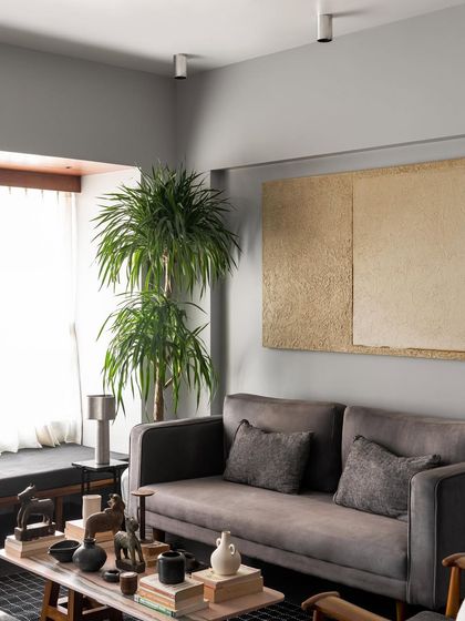 This living room view shows a custom grey sofa and a built-in window seat. I enjoy creating multiple seating options within a single room to accommodate different activities and moods.