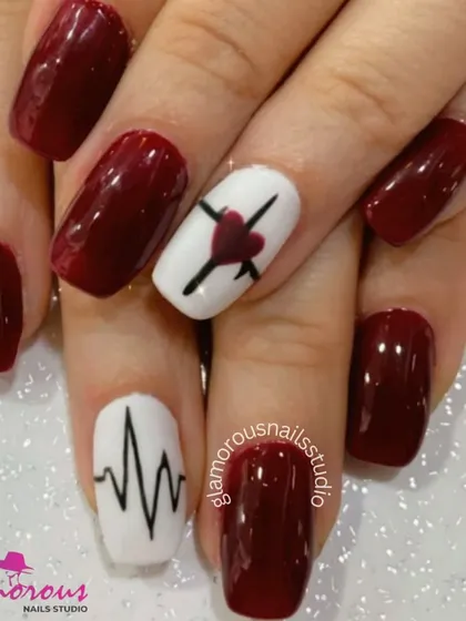 A bold and edgy design with deep red nails and white accent nails featuring a heartbeat line and a crossed-out heart.
