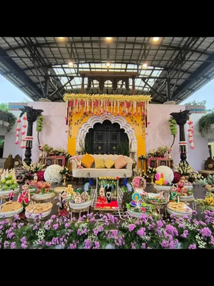 We specialize in creating grand and authentic settings for traditional ceremonies. This elaborate Seemantha (baby shower) setup combines a beautiful floral stage with a full display of traditionally decorated plates, ensuring every detail is perfect.