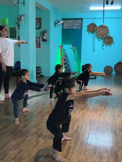 Teaching the perfect squat position. This fundamental move builds strength in the legs and core, which is essential for all forms of dance.