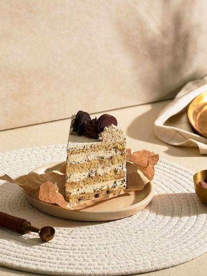 My Cookie and Cream Cake is a classic combination. It has a vanilla sponge with Oreo cream cheese frosting and is garnished with cookie crumbles and chocolate ganache.