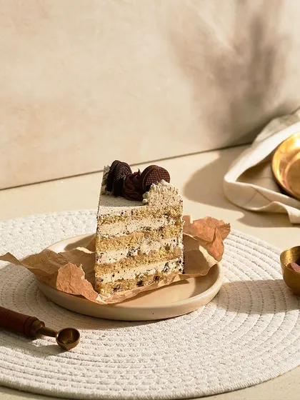 My Cookie and Cream Cake is a classic combination. It has a vanilla sponge with Oreo cream cheese frosting and is garnished with cookie crumbles and chocolate ganache.