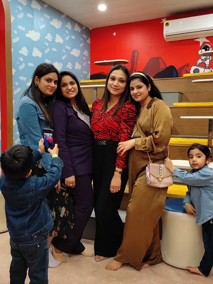 A little photographer in the making! It's fun for the whole family as this little boy snaps a picture of the moms posing.