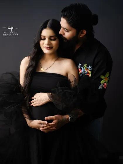 A modern and intimate portrait for the contemporary couple. The simplicity of the black-on-black styling creates a powerful and chic look, focusing entirely on the connection and the beautiful baby bump.