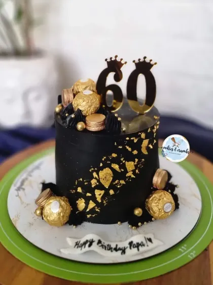 Celebrating a 60th birthday calls for something bold and elegant. This black and gold eggless cake, decorated with Ferrero Rocher chocolates and a custom topper, is a perfect example of a sophisticated design for a major milestone.