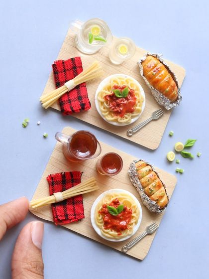 A tiny plate of spaghetti with garlic bread, a pocket-sized trip to Italy.
