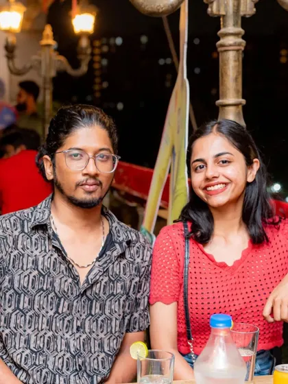 This couple is enjoying the relaxed rooftop atmosphere.