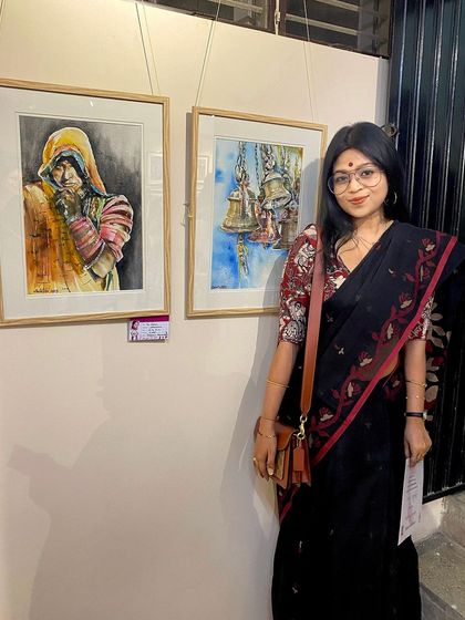 So happy to have two of my artworks displayed at the 'EUPHORIA' Women's Day art show. Here I am next to my paintings, a portrait and a still life of temple bells.