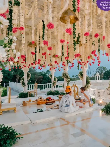 This mandap in a royal palace setting featured a ceiling of hanging tuberoses and pink carnations, creating a fragrant and visually stunning canopy for the pheras.