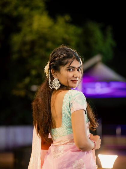 A classic over-the-shoulder portrait. Her glance towards the camera is captivating, and the night lighting adds a touch of glamour to this traditional look.