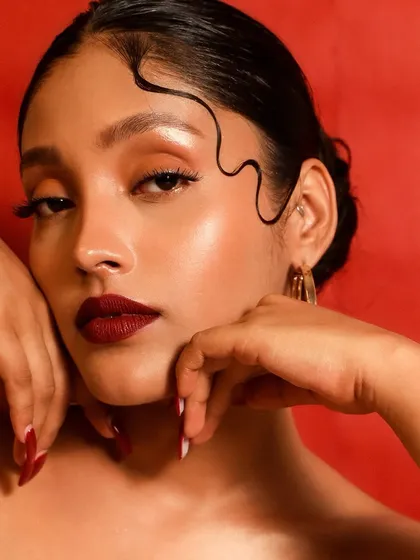 For those who love a bold statement, this look channels timeless Hollywood glamour. A classic, deep red lip paired with clean, radiant skin and sharp winged liner creates an unforgettable and confident style.
