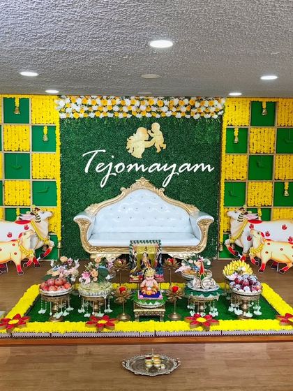 A simple yet elegant baby shower setup with a Krishna-themed backdrop, showing that beauty lies in thoughtful curation, not just quantity.