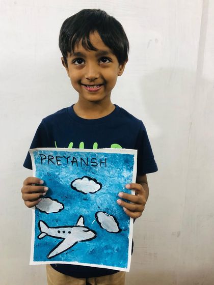 Preyansh shows off his masterpiece from our summer camp canvas painting activity. We love seeing the joy on their faces when they complete their artwork.